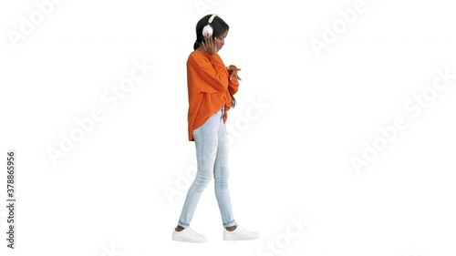 Young african american woman with headphones listening and grooving to music on white background.