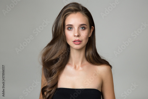 portrait of a woman with wavy hair and makeup. Copycpase
