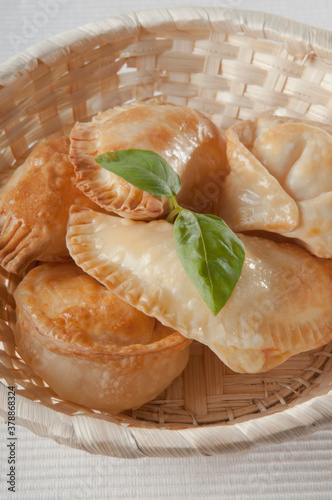 Close-up of fried panzerottis and tortellini in a basket photo