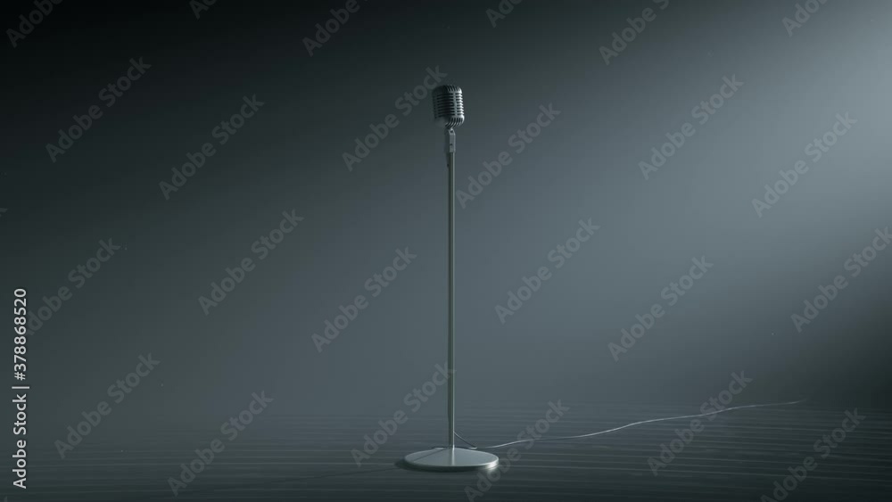 A desaturated vintage microphone on the empty stage. Grey background. Old mic.