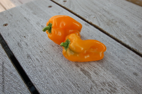 yellow peppers on wooden table