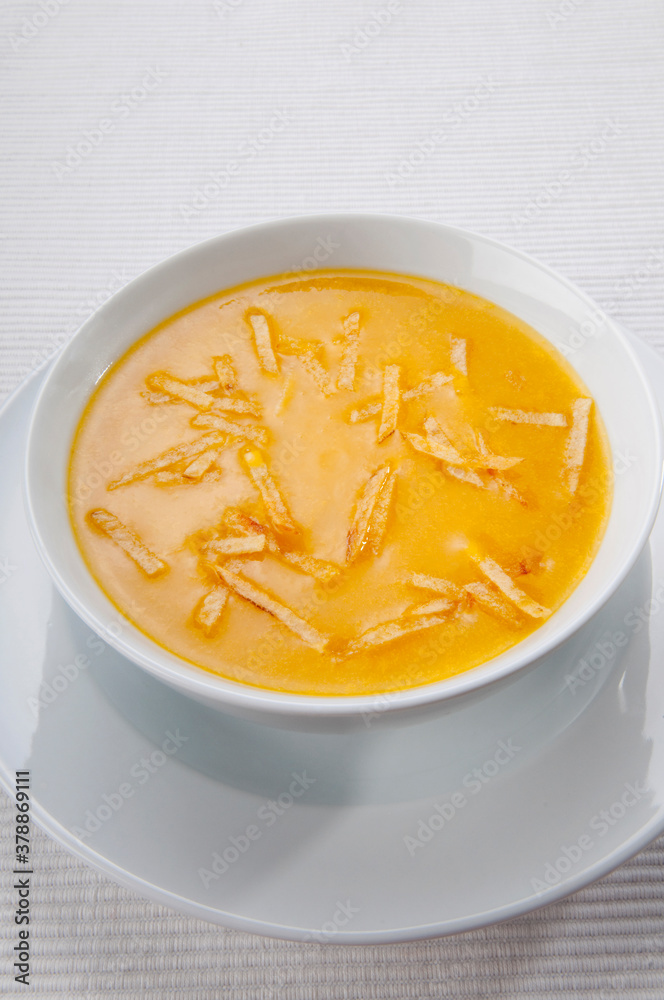 Pumpkin soup being poured into a bowl Pumpkin soup being poured into a bowl