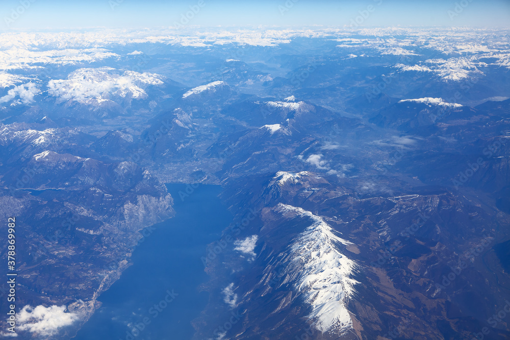 Flying above mountains with snowy peaks