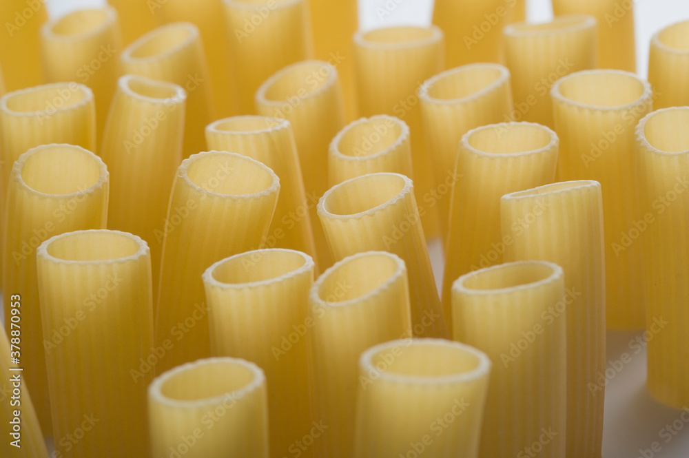 Fototapeta premium Close-up of raw rigatoni on a white background