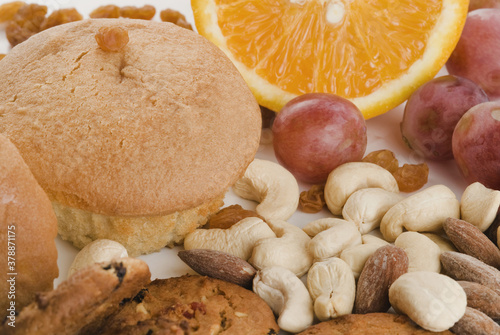 Close-up of nuts and fruits with cookies and muffins