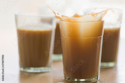 Close-up of tea splashing in glasses