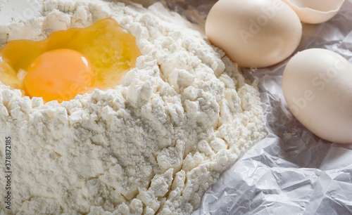 Close-up of egg yolk with flour and eggs