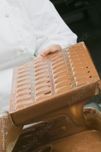 Male chef holding a mold to make chocolate pralines