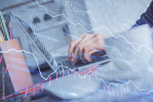 Double exposure of woman hands typing on computer and forex chart hologram drawing. Stock market invest concept.