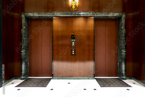 Front of Two close elevators in  old retro style Hotel