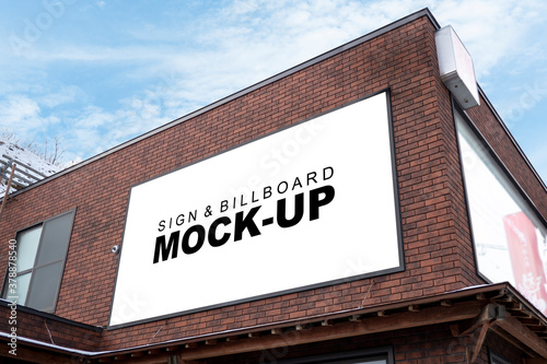 Mock up horizontal outdoors billboard on wall top of building photo