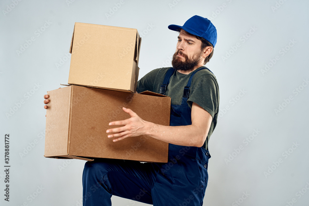 Man in working uniform with boxes in hands delivery loading lifestyle
