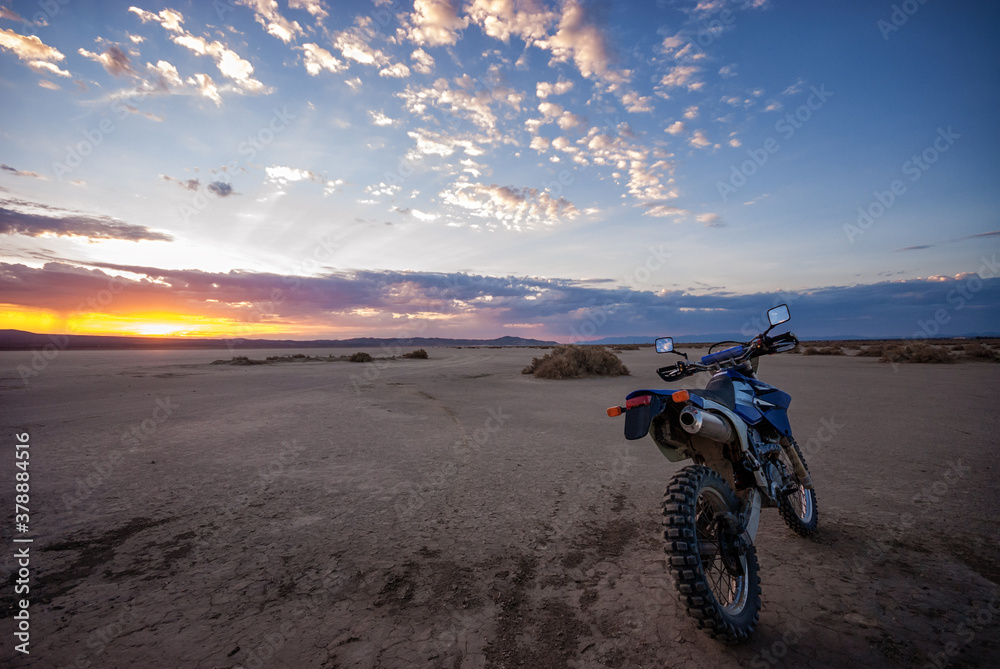 Dual Sport dirt bike on El-mirage dry lake at sunrise Dual Sport dirt bike on El-mirage dry lake at sunrise