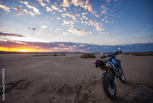 Dual Sport dirt bike on El-mirage dry lake at sunrise photo