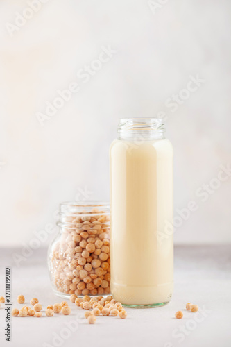 Vegetable pea milk in a bottle and peas in a jar. Gluten free, lactose free product