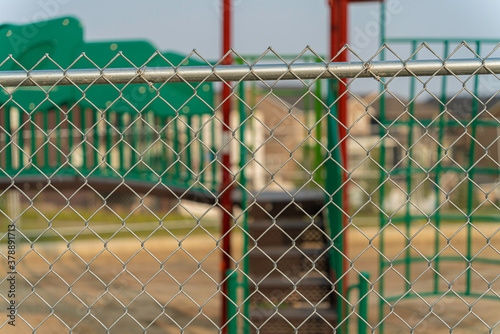 Childrend playground under construction behind a fence photo