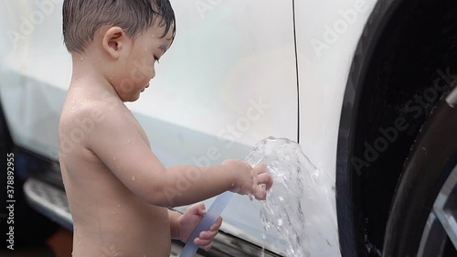 Baby boy washing car