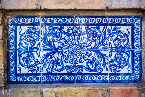 Seville, Spain. October 14th, 2020. Decorative ceramic tiles on the perimeter wall of the historic tobacco factory building on Calle San Fernando, now home to the university.