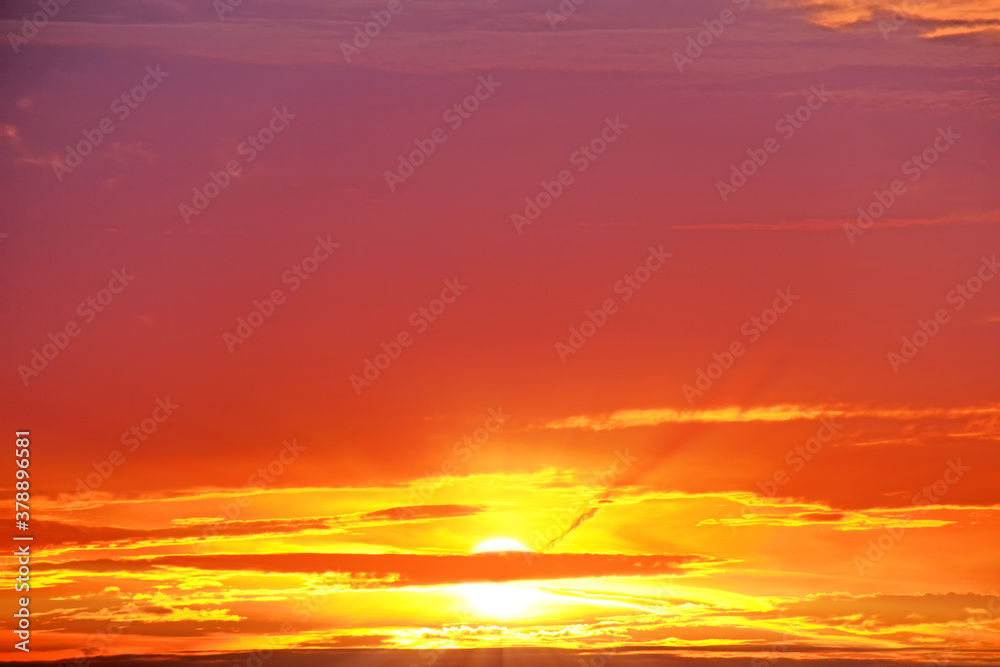 red sunset sky landscape background natural color of evening cloudscape panorama with setting sun and clouds. Autumn colors of sky. Golden hour