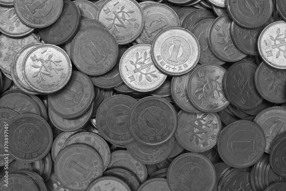 Surface of Japanese 1 one yen coins close-up. Black and white dark background or wallpaper. The backdrop on the theme of finance, the central bank or the economy of Japan. View from above. Macro Surface of Japanese 1 one yen coins close-up. Black and white dark background or wallpaper. The backdrop on the theme of finance, the central bank or the economy of Japan. View from above. Macro
