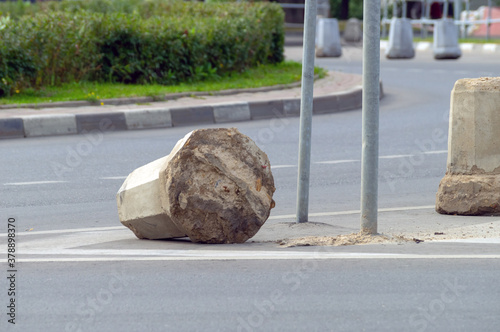 The concrete fence at the bend in the road lies broken