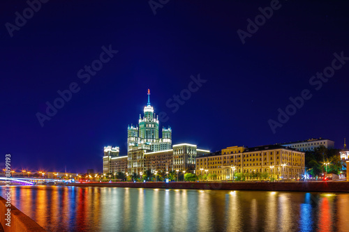 Stalin Skyscraper on Kotelnicheskaya Embankment of the Moscow River. Night shot of Moscow river reflection.