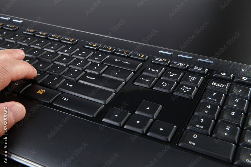 person typing on a laptop keyboard