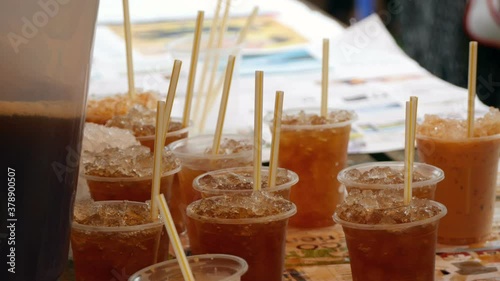 Iced coffee with straw in plastic cup ready for served