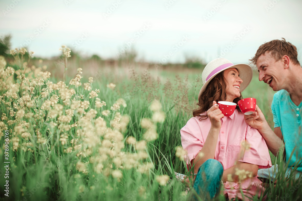 Love couple with hot tea in park. Couple in love. Sensual. Tea cup. Love couple with hot tea in park. Couple in love. Sensual. Tea cup.