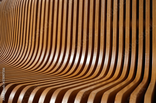 beautiful texture of curved lacquered wood slats as background