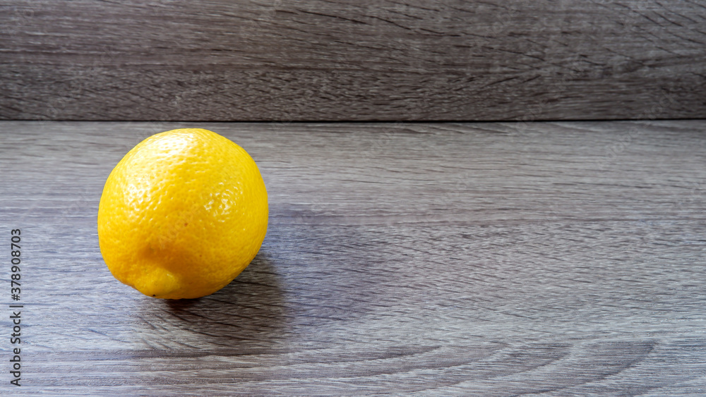 Whole lemon on wooden surface table