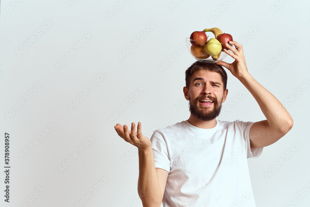 Naklejka premium man with fresh fruit in a glass cup gesturing with hands vitamins health energy model bushy beard mustache