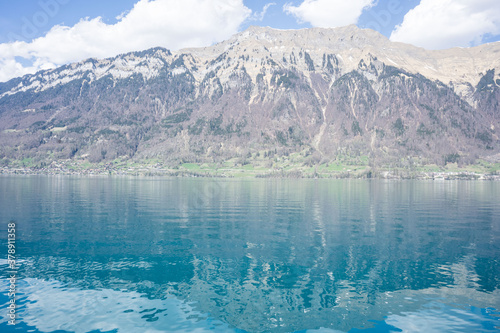 Beautiful lake in Swiss Alps in a sunny spring day with reflections in the lake water  bright colourful lake water