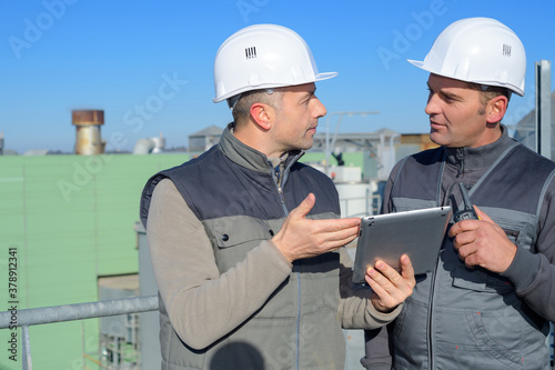two construction workers using tablet