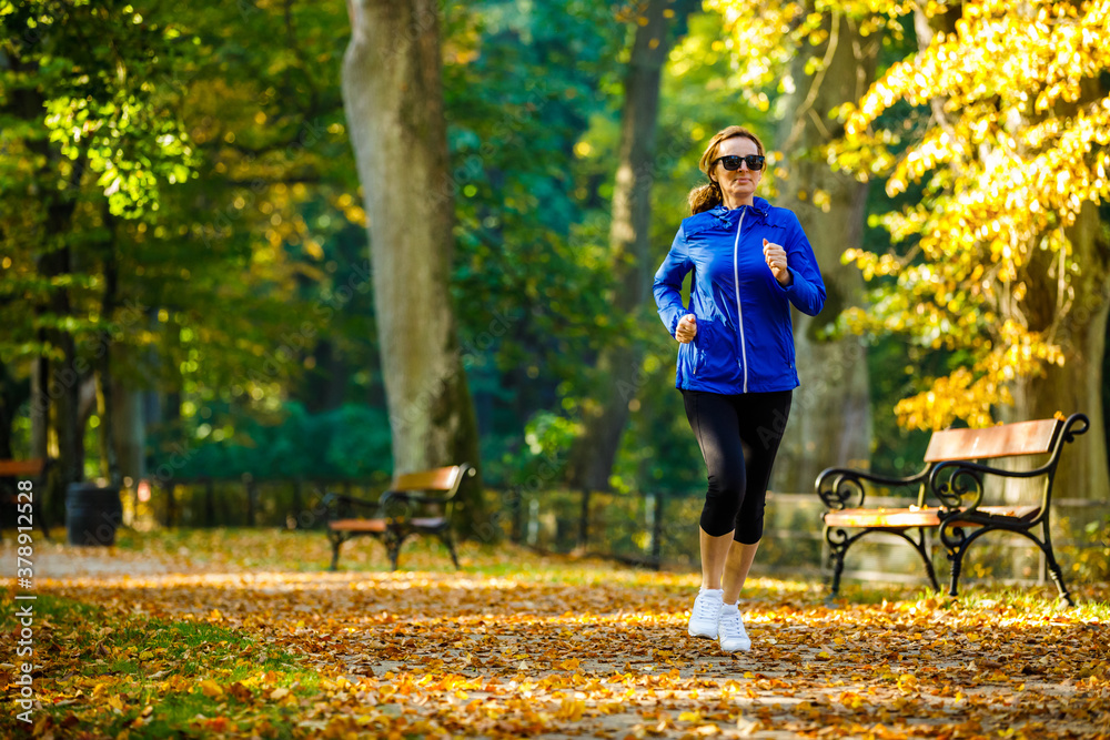 Healthy lifestyle - woman running in city park