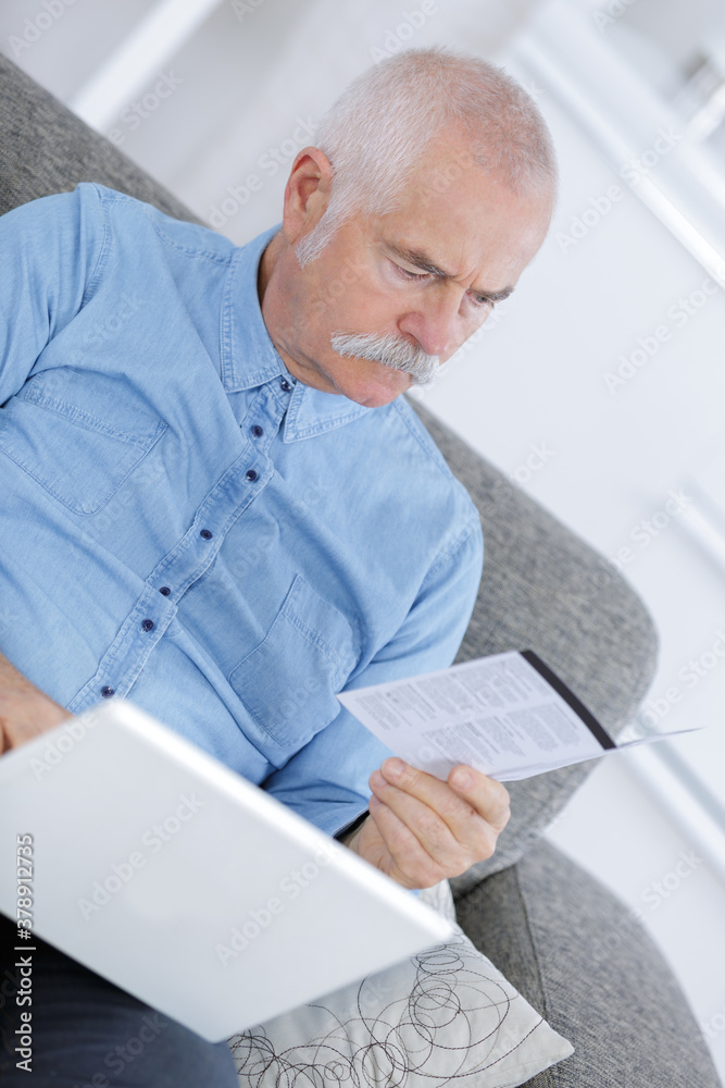 mature man at home using laptop mature man at home using laptop