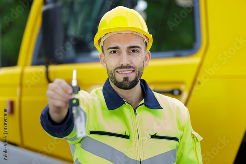 portrait of a worker showing key