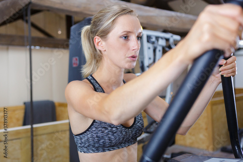 woman working out on an elliptical trainer in gym