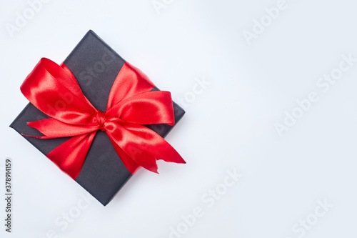 Black friday sale flat lay with gift box and ribbon, copy space, christmas and holidays concept on white background