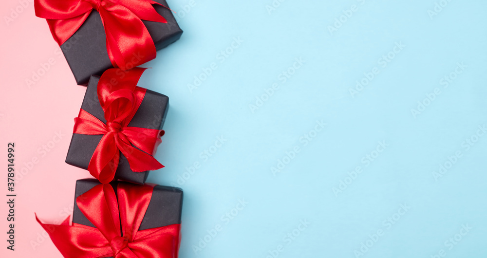 Black friday sale flat lay with gift box and ribbon, copy space, christmas and holidays concept on pink blue background Black friday sale flat lay with gift box and ribbon, copy space, christmas and holidays concept on pink blue background
