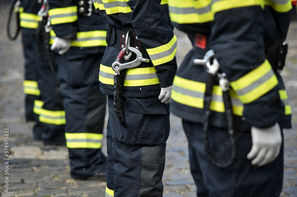 Fire fighters uniform detail with carabiner and harness during ceremony Fire fighters uniform detail with carabiner and harness during ceremony