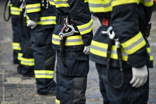 Fire fighters uniform detail with carabiner and harness during ceremony