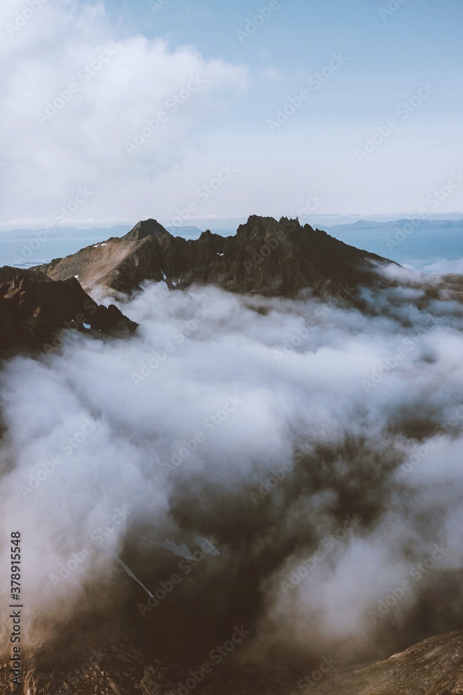 Aerial mountain peak view above clouds landscape in Norway travel beautiful destinations wilderness nature scenic Senja island