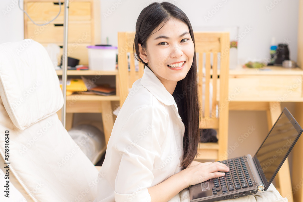 Business women sitting on sofa wooden chair use laptop computer in modern room Business women sitting on sofa wooden chair use laptop computer in modern room