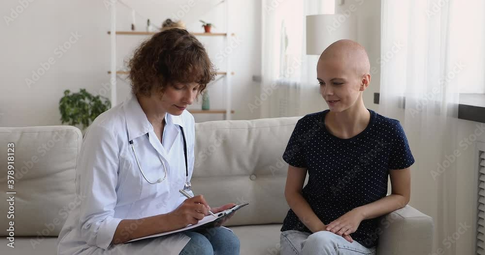 custom made wallpaper toronto digitalMiddle aged female nurse in white uniform listening to cancer patient 25s bald girl at checkup visit at home, oncologist filling medical form provide consultation after oncology therapy rehabilitation