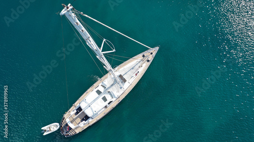 Aerial drone top down photo of beautiful sailboat anchored in Aegean sea © aerial-drone