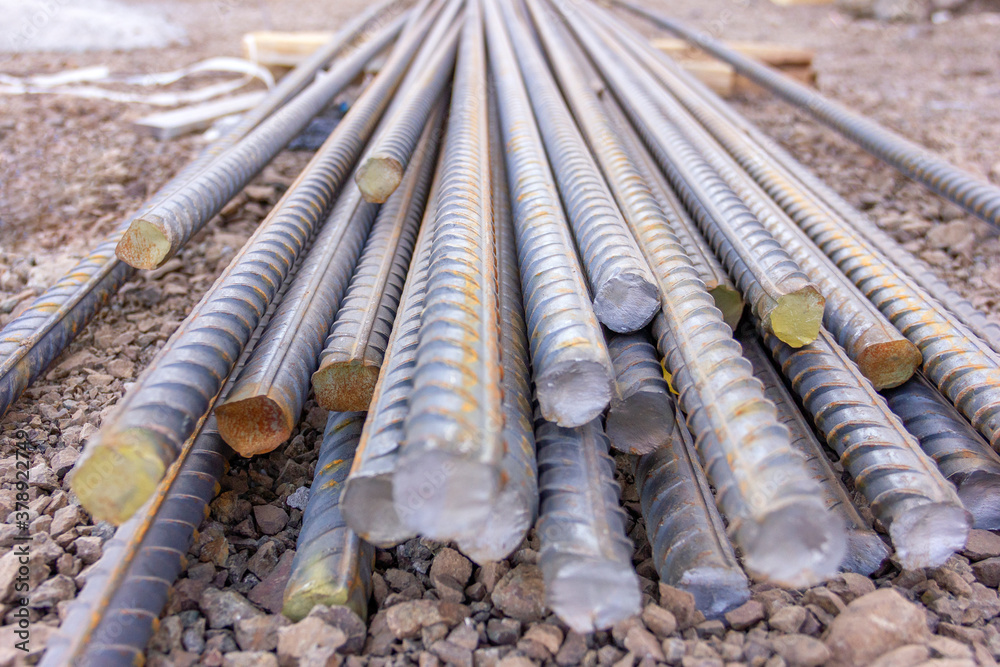Close up view of the concrete steel rebars in the construction site. Rebar (reinforcing bar), known when massed as reinforcing steel or reinforcement steel.