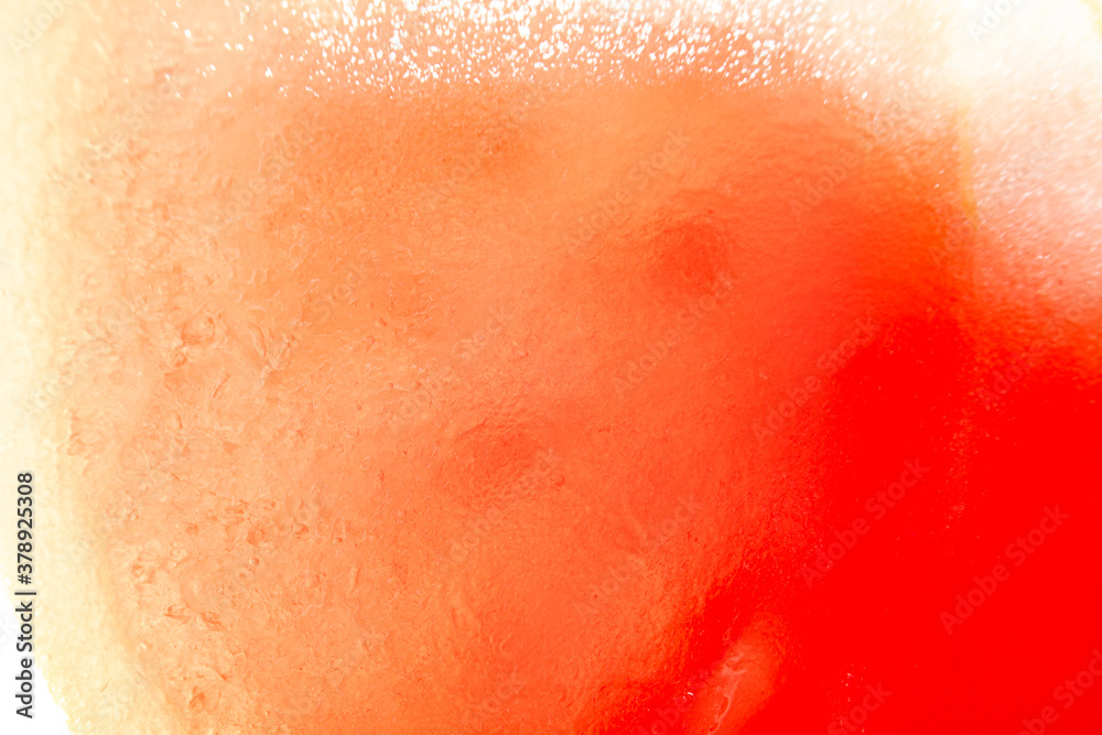 Fototapeta premium Background with sliced tomato under strong magnification in soft focus. A detailed image of the pulp of a ripe tomato.
