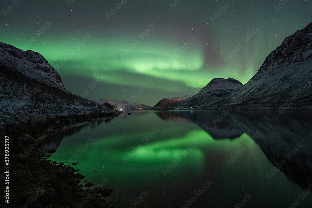 Beautiful Norwegian fjord reflection of the northern lights (aurora borealis)