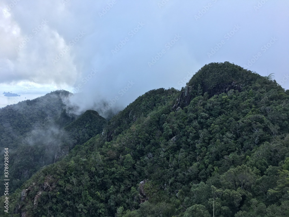 Thick dense mountains with clouds covering